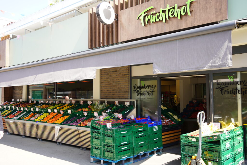 Große Warenauslage mit Obst vor dem Eingang des Früchtehofs